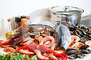 Fresh raw seafoods and fish in kitchen photo