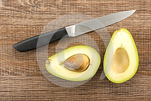 Fresh raw smooth avocado on brown wood photo