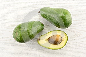 Fresh raw smooth avocado on grey wood