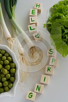 Fresh raw spring vegetables on white background