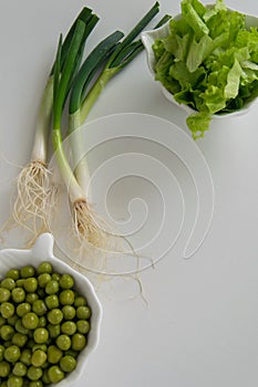 Fresh raw spring vegetables on white background