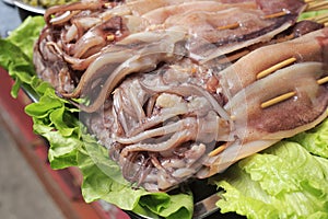 Fresh raw squid with bamboo stick
