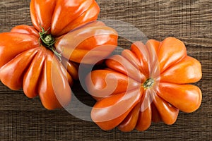 Fresh raw Tomato Beef tomato variety on brown wood