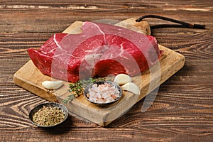 Fresh raw top side beef steak on wooden tabletop