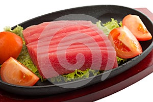 Fresh raw tuna fish pieces on plate isolated