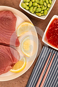 Fresh Raw Uncooked Yellow Fin Tuna Steaks With Lemon Slices
