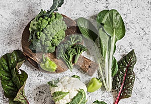 Fresh raw vegetables - broccoli, cauliflower, chard, peppers on a light background