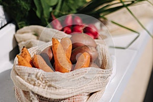 Fresh raw vegetables in eco canvas grocery bag. Cotton bags with vegetables. Zero waste shopping concept. Plastic free