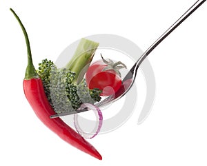 Fresh raw vegetables on fork isolated on white background cutout