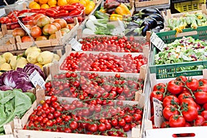 Fresh raw vegetables in wooden boxes