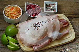 Fresh raw whole duck ready for cooking with apples, cranberries