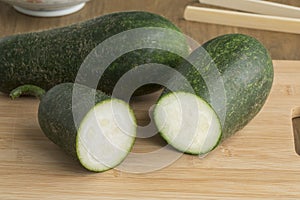 Fresh raw whole and half hairy cucumber