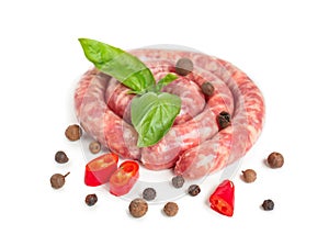 Fresh raw wurst with basil and pepper on white background
