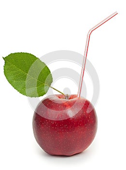 Fresh red apple with drinking straw inside, making juice concept. Isolated on white background, close up