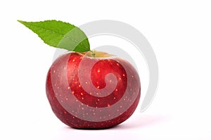 Fresh red apple with green leaf isolated on white