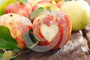 Fresh red apple with heart cutout