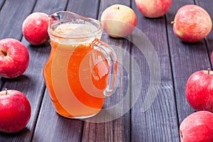 Fresh red apple juice in the pitcher table