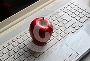 Fresh Red Apple On Laptop Keypad With Latin And Cyrillic Characters