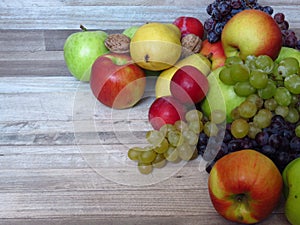 Fresh red and baked apples, shortbread biscuits, and cinnamon sticks on rustic style oak wood background. photo