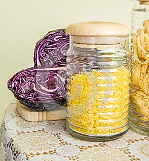 Fresh red cabbage cut in half and jars with pasta