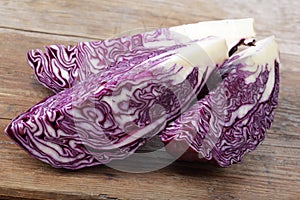 Fresh red cabbage pieces on oak table
