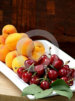 Fresh red cherries and apricots