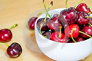 Fresh red cherries fruit on wooden floor background