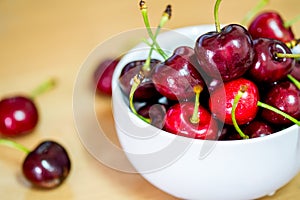 Fresh red cherries fruit on wooden floor background