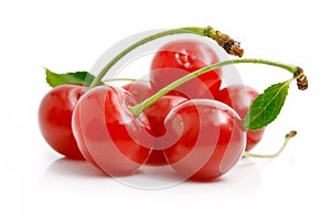 Fresh red cherries with green leaves