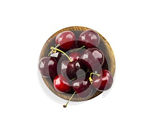 Fresh red cherries lay on white isolated background with copy space. Cherries in a wooden bowl. Background of cherries. Ripe cherr