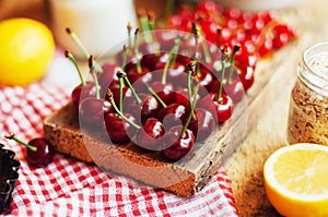 Fresh red cherries on a rustic wooden table. Ripe cherries i o