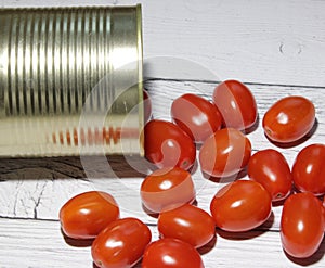 Fresh red cherry tomatoes spilled from a can