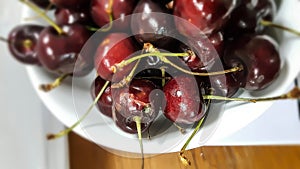 Fresh red cherry in white bowl