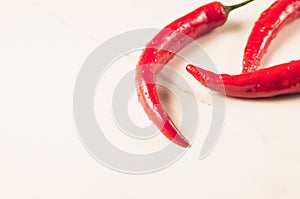 Fresh red chili pepper/fresh red chili pepper on a white marble