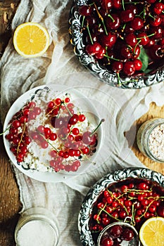 Fresh red currant on wooden table, bucket with red currant berri