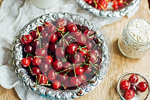 Fresh red currant on wooden table, bucket with red currant berri