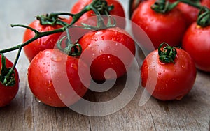 Fresh red delicious tomatoes on an old wooden tabletop, select