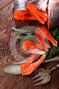 Fresh red fish on a wooden background. Natural omega. Healthy food. Flat lay. Top view.