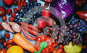 Fresh red fruit and purple red vegetables mixed background , top view various for healthy food vegan cook - Healthy food selection