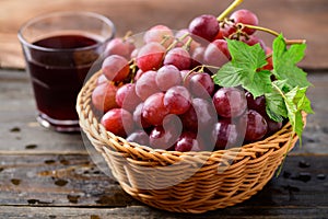 Fresh red grapes fruit in a basket and juice