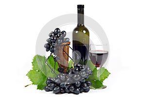 Fresh Red Grapes with Green Leaves, Wine Glass Cup and Wine Bottle Filled with Red Wine Isolated on White