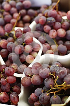 Fresh red grapes on store counter