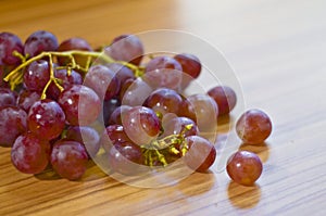 Fresh red grapes on wooden table