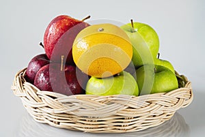 Fresh colorful apple with water drop on skin over gray background