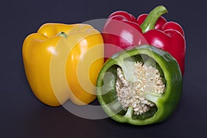 Fresh red green yellow Bell Pepper Slices on darck background