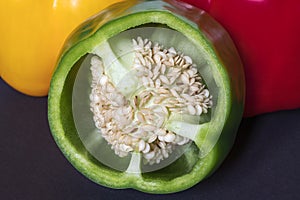 Fresh red green yellow Bell Pepper Slices on darck background