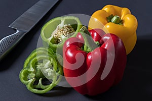 Fresh red green yellow Bell Pepper Slices on darck background