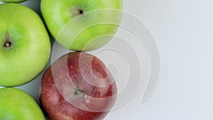 Fresh red and greens apples on a white background. Rotation