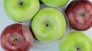 Fresh red and greens apples on a white background. Rotation