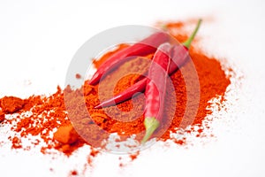 fresh red hot pepper and powder on a white background